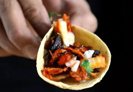 Taco al pastor con piña y cilantro